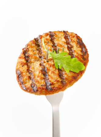Grilled patty on a forkの写真素材