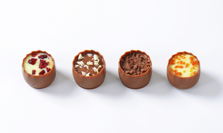 Delicate milk chocolate cups with liqueur and ganache centresの写真素材