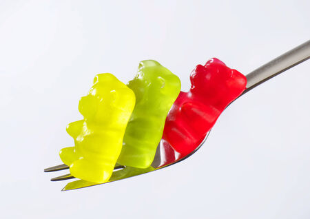 Three gummy bears on a forkの写真素材
