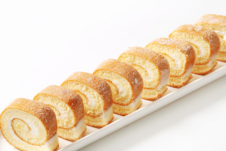 Slices of sponge cake roll with cream fillingの写真素材
