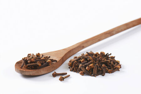 Dried cloves on wooden spoonの写真素材