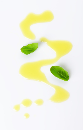 Olive oil drizzle and fresh basil leavesの写真素材