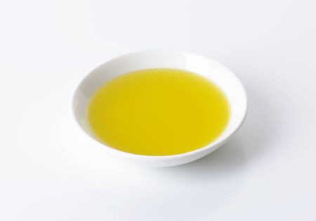 Olive oil in white porcelain bowlの写真素材