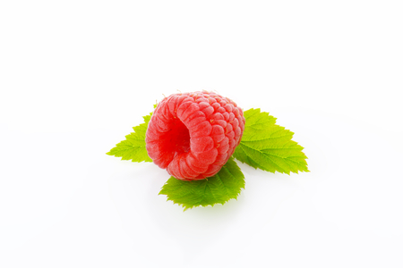 Fresh raspberry with leaves on white backgroundの写真素材