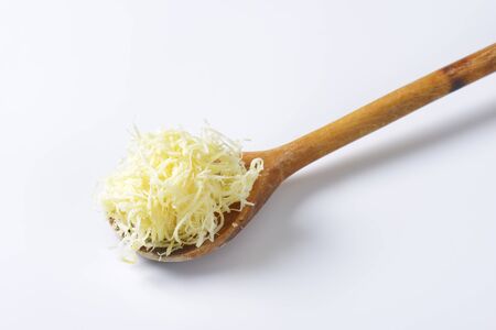 Freshly shredded horseradish on a wooden spoonの写真素材