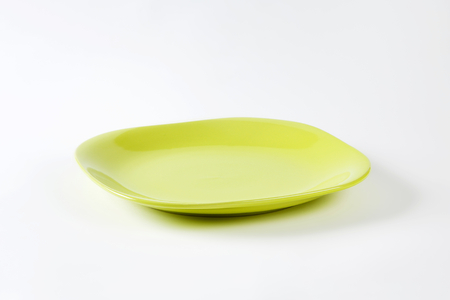 Square shaped yellow green  plate with rounded cornersの写真素材