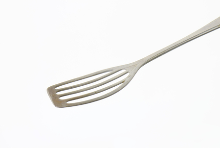 Metal spatula with perforated blade that allows liquids to drain throughの写真素材
