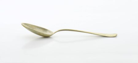 Old silver spoon covered with tarnishの写真素材