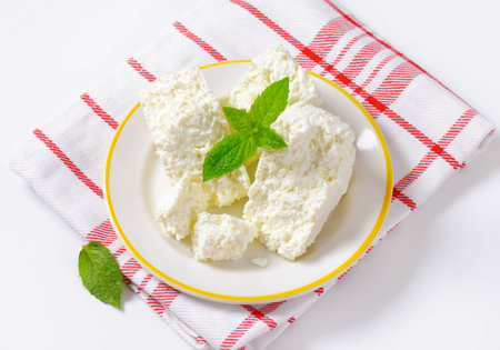 Crumbly white cheese on plateの写真素材