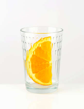 Orange wedge in empty glassの写真素材