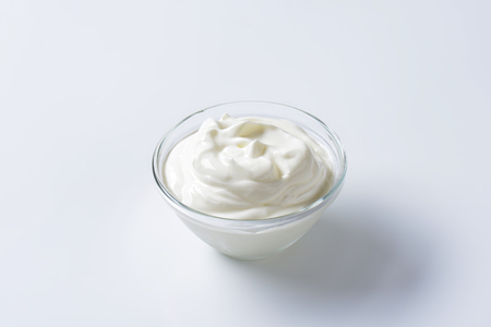 bowl of sour cream on white backgroundの写真素材