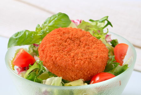 Fried breaded cheese with green saladの写真素材