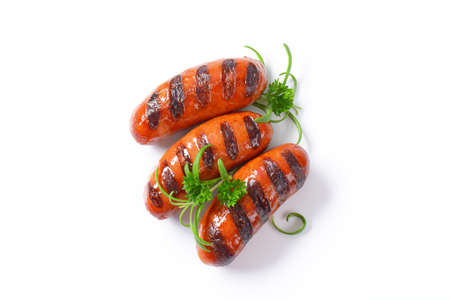 three grilled sausages on white backgroundの写真素材