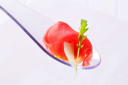 Thin slice of raw beef on spoonの写真素材
