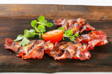 Grilled thin sliced pork on dark brown woodの写真素材