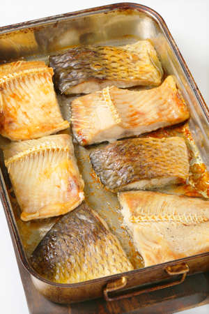 Oven baked carp fillets in baking panの写真素材