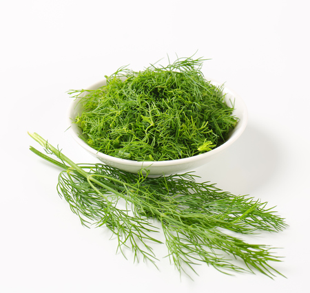 Bowl of fresh chopped dill leavesの写真素材