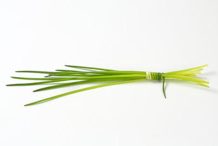 Bunch of fresh chives on white backgroundの写真素材