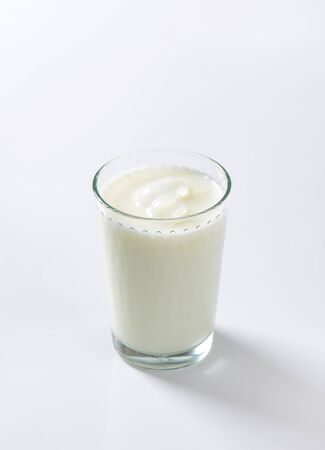 glass of milk on white backgroundの写真素材