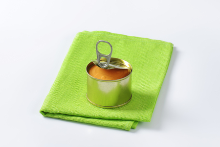 canned pate on folded green clothの写真素材