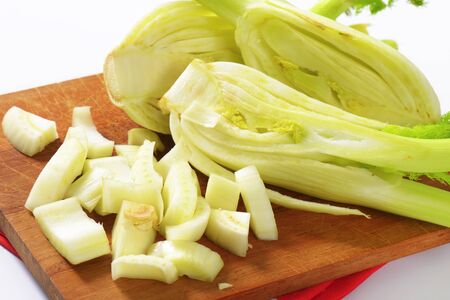 detail of fennel bulbs on wooden cutting boardの写真素材