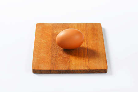 egg on wooden cutting board