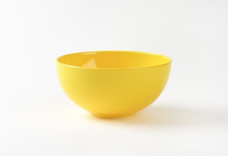 empty yellow bowl on white backgroundの写真素材