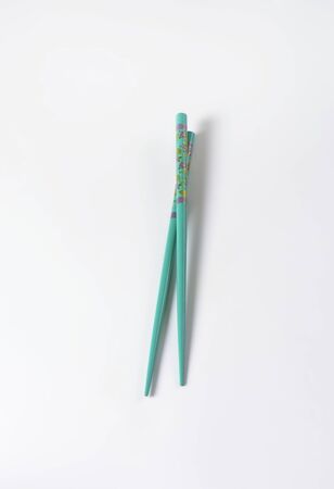 pair of blue chopsticks on white backgroundの写真素材