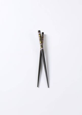 pair of black chopsticks on white backgroundの写真素材
