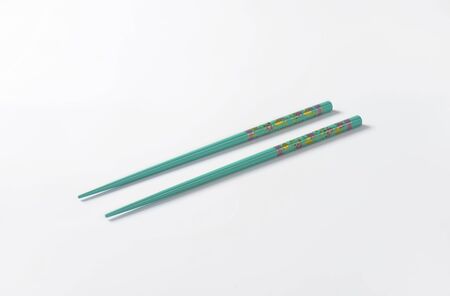 pair of blue chopsticks on white backgroundの写真素材