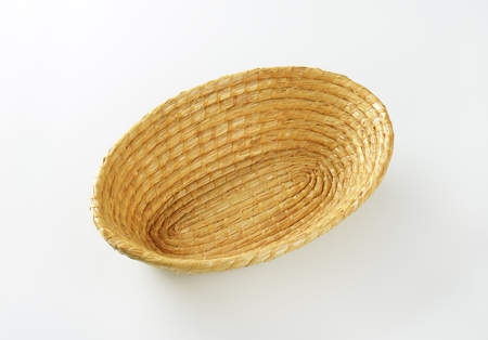 empty wicker bowl on white backgroundの写真素材