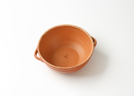 empty orange bowl on white backgroundの写真素材