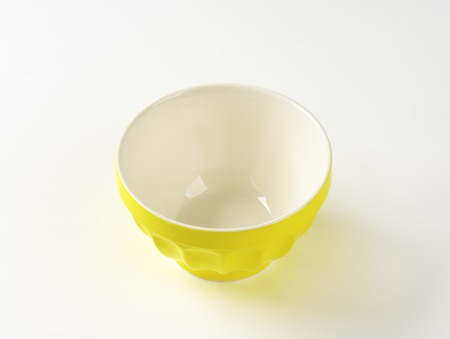 empty yellow bowl on white backgroundの写真素材