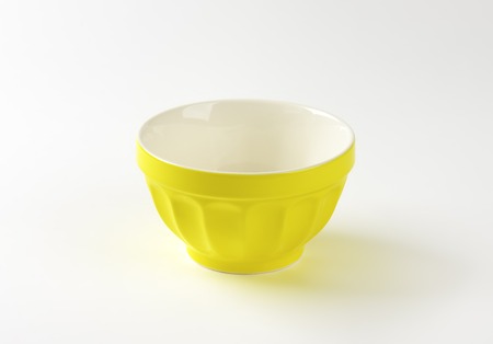 empty yellow bowl on white backgroundの写真素材