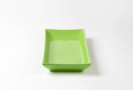 empty green tray on white backgroundの写真素材