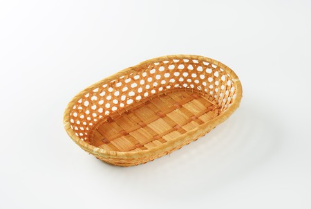 empty wicker bowl on white backgroundの写真素材