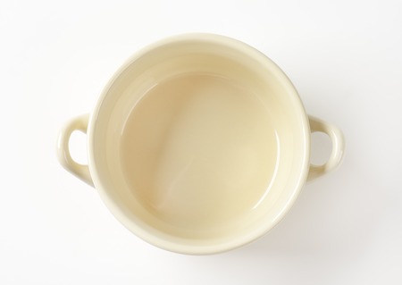 empty beige bowl on white backgroundの写真素材