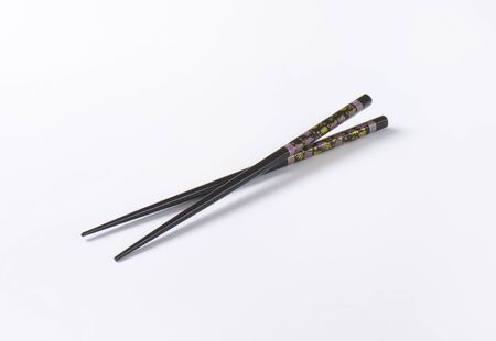 pair of black chopsticks on white backgroundの写真素材