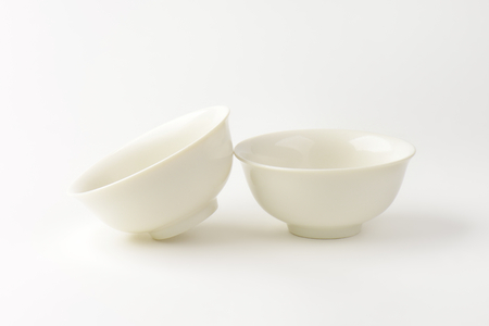 two white bowls on white backgroundの写真素材