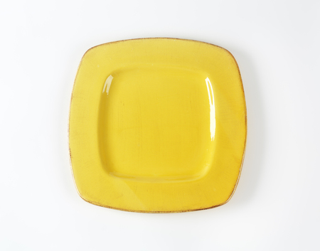 yellow square plate on white backgroundの写真素材