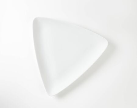 white triangular plate on white backgroundの写真素材