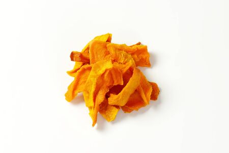 Heap of dried mango slices on white backgroundの写真素材