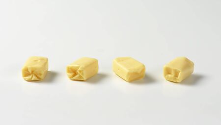 Four milk chewy candies on white backgroundの写真素材