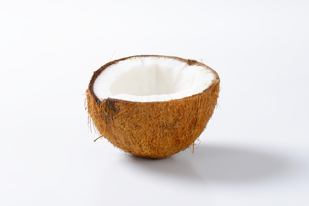 Half a coconut on white backgroundの写真素材