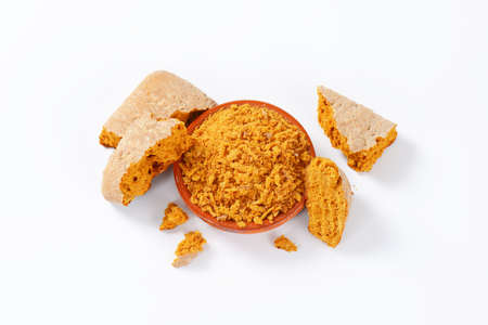 Gingerbread grated into fine pieces in terracotta dish