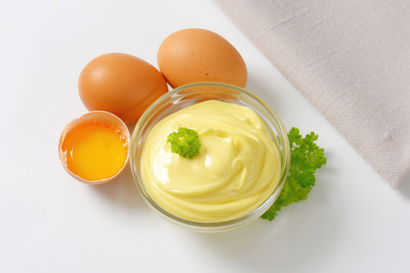 Bowl of homemade mayonnaise and fresh eggsの写真素材