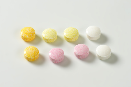 Lentil-shaped fruit flavor candy in soft pastel colorsの写真素材