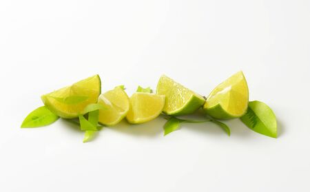 Fresh lime wedges in a rowの写真素材