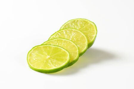 Slices of fresh lime on white backgroundの写真素材