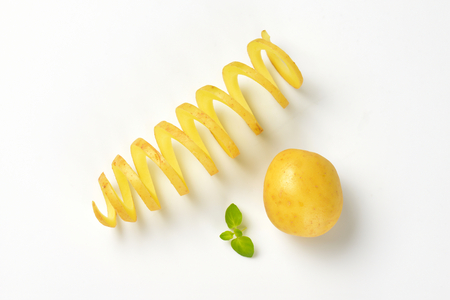 whole potato and spiral-cut potatoの写真素材